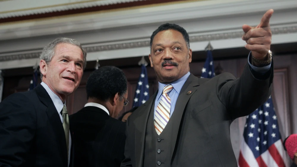 FILE - President George W. Bush speaks with Rev. Jesse Jackson, right, after signing a bill in the Eisenhower Executive Office Building, Dec. 1, 2005, authorizing a statue of civil rights leader Rosa Parks be placed in the U.S. Capitol