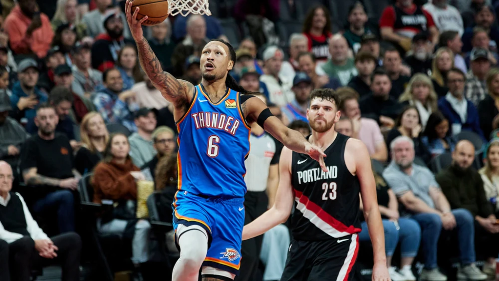 Oklahoma City Thunder forward Jaylin Williams, left, shoots in front of Portland Trail Blazers center Donovan Clingan during the second half of an NBA basketball game in Portland, Ore., Wednesday, Nov. 5, 2025. (AP Photo/Craig Mitchelldyer)