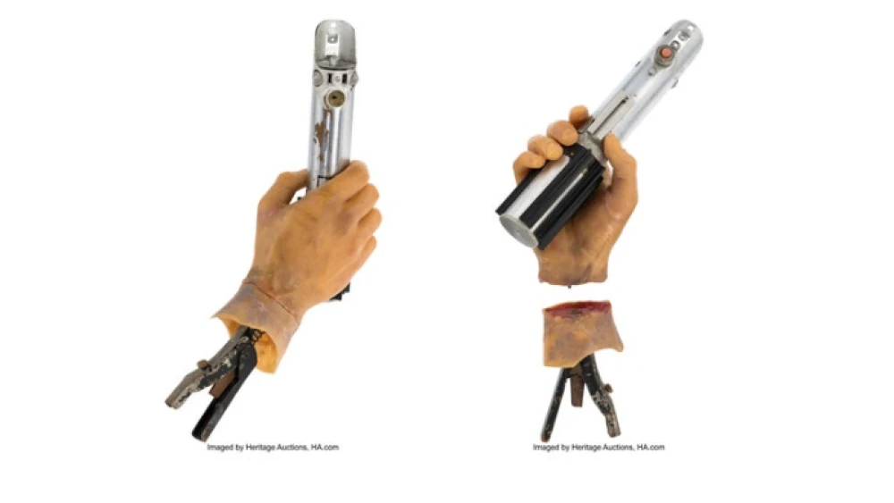 This combination of images released by Heritage Auctions show the light saber used on screen by Mark Hamill
